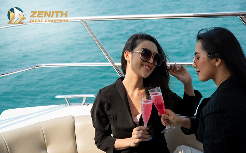 Friends toasting with pink champagne on a yacht.
